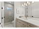 Modern bathroom featuring a marble walk-in shower, white vanity with light wood cabinets, and stylish fixtures at 16730 Collingtree Xing, Lakewood Ranch, FL 34202