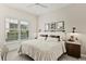 Serene bedroom featuring a comfortable bed, plantation shutters, and stylish nightstands with lamps at 16730 Collingtree Xing, Lakewood Ranch, FL 34202