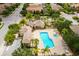 Aerial view of the community pool and clubhouse, surrounded by lush landscaping and seating areas at 16730 Collingtree Xing, Lakewood Ranch, FL 34202