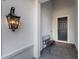 Inviting covered front porch with a welcome bench and decorative wall lantern at 16730 Collingtree Xing, Lakewood Ranch, FL 34202