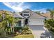 Beautiful home exterior with a well-manicured lawn and tropical landscaping at 16730 Collingtree Xing, Lakewood Ranch, FL 34202