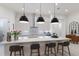 Open kitchen featuring a large island, modern pendant lighting, and sleek countertops at 16730 Collingtree Xing, Lakewood Ranch, FL 34202