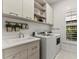 Bright laundry room featuring modern appliances, a sink, and ample storage space at 16730 Collingtree Xing, Lakewood Ranch, FL 34202