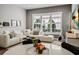 Cozy living room with a white sofa, large window with shutters, and decorative accents at 16730 Collingtree Xing, Lakewood Ranch, FL 34202