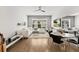 Bright living room with wood floors, a plush white sofa, and a large window with shutter detail at 16730 Collingtree Xing, Lakewood Ranch, FL 34202