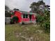 Charming one-story home with vibrant red exterior, quaint front porch, and well-maintained yard at 1711 41St S St, St Petersburg, FL 33711