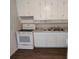 Bright kitchen featuring white cabinetry, a stainless steel sink, and an electric range at 1711 41St S St, St Petersburg, FL 33711