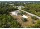 This aerial view shows the generous lot space and mature trees surrounding this house, suggesting peaceful suburban living at 17555 Lake Worth Blvd, Port Charlotte, FL 33948