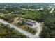 Aerial view of a property showcasing its setting on a large lot with lush greenery, providing a serene and private atmosphere at 17555 Lake Worth Blvd, Port Charlotte, FL 33948