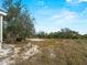 Spacious backyard with trees and natural landscape, showcasing the property's outdoor space at 17555 Lake Worth Blvd, Port Charlotte, FL 33948