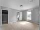 Bedroom with abundant natural light featuring neutral paint and doors leading to closet and hallway at 17555 Lake Worth Blvd, Port Charlotte, FL 33948