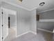 Spacious bedroom featuring white trim, light gray walls, and an open doorway to another room at 17555 Lake Worth Blvd, Port Charlotte, FL 33948