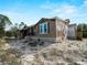 Exterior view of a home, featuring a wraparound porch and gravel landscaping at 17555 Lake Worth Blvd, Port Charlotte, FL 33948