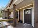 Charming front porch with wooden support columns and dark brown front door at 17555 Lake Worth Blvd, Port Charlotte, FL 33948