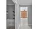 Hallway leading to a room with wood paneling, revealing interior design details at 17555 Lake Worth Blvd, Port Charlotte, FL 33948