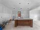 Elegant kitchen island with marble countertop and custom wooden base in an unfinished space at 17555 Lake Worth Blvd, Port Charlotte, FL 33948