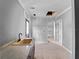 Bright laundry room featuring a sink with light countertops and an adjacent doorway at 17555 Lake Worth Blvd, Port Charlotte, FL 33948