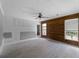 Spacious living room with wood accent wall, ceiling fan, and abundant natural light at 17555 Lake Worth Blvd, Port Charlotte, FL 33948