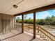 View from covered porch with wooden posts, railings, steps, and outdoor scenery at 17555 Lake Worth Blvd, Port Charlotte, FL 33948