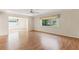 Bright living room with wood-look flooring and natural light flooding through a large window at 1873 University Pl # 135, Sarasota, FL 34235