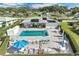 Community pool and sun deck offer a relaxing outdoor space with chairs and tables at 1873 University Pl # 135, Sarasota, FL 34235