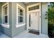 Inviting entryway with a white door and side windows at 2006 Red Lake Run, Bradenton, FL 34211