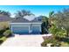 Two story house with three car garage and manicured lawn at 2006 Red Lake Run, Bradenton, FL 34211