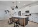 Modern kitchen with white cabinets, island and breakfast bar at 2006 Red Lake Run, Bradenton, FL 34211