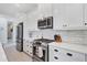 Modern kitchen with stainless steel appliances and white cabinets at 2006 Red Lake Run, Bradenton, FL 34211