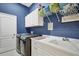 Laundry room with washer, dryer, and built-in cabinets at 2006 Red Lake Run, Bradenton, FL 34211