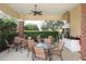 Covered outdoor kitchen and dining area with grill at 2006 Red Lake Run, Bradenton, FL 34211