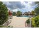 Relaxing pool area with patio furniture and umbrellas at 2006 Red Lake Run, Bradenton, FL 34211