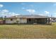 Wide view of the backyard of the home and a screened-in porch at 20313 Navajo Ln, Port Charlotte, FL 33952