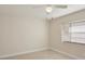 Bright bedroom with tiled floors, a ceiling fan, and a sun-filled window at 20313 Navajo Ln, Port Charlotte, FL 33952