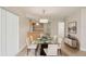 Dining area with a glass-top table, white chairs, and stylish decor at 20313 Navajo Ln, Port Charlotte, FL 33952