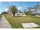 Single-story home featuring a mature palm tree in the front yard adding tropical curb appeal at 20313 Navajo Ln, Port Charlotte, FL 33952