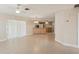 Bright living room featuring tile floors, ceiling fan, and open access to the kitchen at 20313 Navajo Ln, Port Charlotte, FL 33952