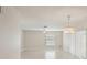 Bright living room with tile floors, featuring neutral walls, ceiling fan and modern chandelier at 20313 Navajo Ln, Port Charlotte, FL 33952