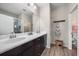 Double vanity bathroom with dark brown cabinets and shower at 220 Alfero Way, Nokomis, FL 34275