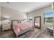 Bedroom with pink bedding, a full-length mirror and wood-look floors at 220 Alfero Way, Nokomis, FL 34275