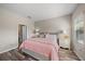 Light and airy bedroom with pink bedding and en-suite bathroom access at 220 Alfero Way, Nokomis, FL 34275