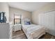 Guest bedroom with white dresser and blue bedding at 220 Alfero Way, Nokomis, FL 34275