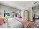 Main bedroom with pink accents and access to sitting area at 220 Alfero Way, Nokomis, FL 34275