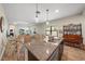 Open kitchen with an island and a view into the dining area at 220 Alfero Way, Nokomis, FL 34275