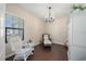 Relaxing sitting room featuring a rocking chair and chandelier at 220 Alfero Way, Nokomis, FL 34275