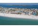 An aerial perspective showcases beach houses lining the water's edge and white sand, offering stunning coastal scenery at 2310 Gulf N Dr # 201, Bradenton Beach, FL 34217