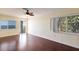 Living room with wood flooring and two windows that show beautiful outside foliage and ocean at 2310 Gulf N Dr # 201, Bradenton Beach, FL 34217