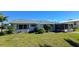 Rear view of the house, showing a screened porch and additional landscaping at 2701 Larkspur Dr, Punta Gorda, FL 33950