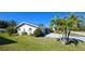 View of the house's side, showcasing the garage and landscaping at 2701 Larkspur Dr, Punta Gorda, FL 33950