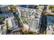 Aerial shot of modern white apartment building with rooftop pool surrounded by palm trees at 300 S Pineapple Ave # 802, Sarasota, FL 34236